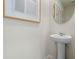 Small bathroom with pedestal sink and round mirror at 2224 Tongass Bnd, Davenport, FL 33837