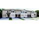 Modern townhome style with attached garages, neutral exterior, and well-manicured lawns at 2224 Tongass Bnd, Davenport, FL 33837