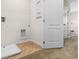 Bright laundry room with built-in shelving and tile flooring at 2224 Tongass Bnd, Davenport, FL 33837