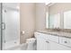 Clean bathroom with granite countertop, white cabinets, and shower at 604 Golfpark Dr, Celebration, FL 34747