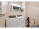 Laundry room with washer, dryer, and shelving at 2952 Cherry Blossom Loop, Saint Cloud, FL 34771