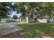 Landscaped backyard with a large tree and concrete pathway at 4707 Tinsley Dr, Orlando, FL 32839