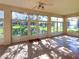 Sunroom with tile floor, large windows, and access to the backyard at 24023 Robinwood St, Leesburg, FL 34748