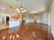 Combined dining and Gathering room with wood floors and kitchen access at 24023 Robinwood St, Leesburg, FL 34748