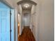 Hallway with wood flooring and access to bedrooms and bathroom at 24023 Robinwood St, Leesburg, FL 34748