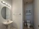 Convenient powder room with pedestal sink and storage cabinet at 24023 Robinwood St, Leesburg, FL 34748