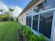 Exterior view showing a house with a large window and green landscaping at 24023 Robinwood St, Leesburg, FL 34748
