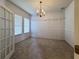 Formal dining room with chandelier and carpet flooring at 24023 Robinwood St, Leesburg, FL 34748