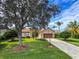 One-story home with mature landscaping and driveway at 24023 Robinwood St, Leesburg, FL 34748