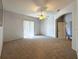 Bright main bedroom with carpet flooring, ceiling fan and sliding glass doors at 24023 Robinwood St, Leesburg, FL 34748