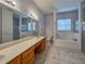 Large bathroom with double vanity, separate shower, and soaking tub at 24023 Robinwood St, Leesburg, FL 34748