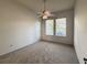 Spacious bedroom with carpet flooring and ceiling fan at 24023 Robinwood St, Leesburg, FL 34748