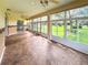 Bright sunroom with tile flooring, ceiling fan and view of backyard at 24023 Robinwood St, Leesburg, FL 34748