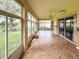 Bright and spacious sunroom with tile floors and access to backyard at 24023 Robinwood St, Leesburg, FL 34748