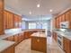 Large kitchen with an island, ample counter space, and views to Gathering room at 24023 Robinwood St, Leesburg, FL 34748