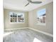 Bright bedroom featuring wood-look tile floors and ceiling fan at 4618 Millcove Dr, Orlando, FL 32812