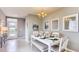 Bright dining room with white table, bench, and chandelier at 2847 Moulin Rd, Davenport, FL 33837