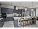 Modern kitchen with large island and stainless steel appliances at 1604 Evening Summit Cir, Minneola, FL 34715