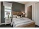 Cozy bedroom with striped bedding and en-suite bathroom at 1604 Evening Summit Cir, Minneola, FL 34715
