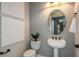 Elegant powder room with pedestal sink and modern fixtures at 1604 Evening Summit Cir, Minneola, FL 34715