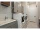 Functional laundry room with washer, dryer, and cabinets at 1604 Evening Summit Cir, Minneola, FL 34715