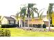 One-story house with palm trees, manicured lawn, and attached garage at 3070 Silver Fin Way, Kissimmee, FL 34746