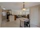 Open kitchen with breakfast bar, dark appliances, and white cabinets at 938 Framlingham Ct # 102, Lake Mary, FL 32746