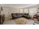 Living room with L-shaped sofa, fireplace, and large windows at 938 Framlingham Ct # 102, Lake Mary, FL 32746