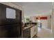 Kitchen with black appliances and view into living room at 938 Framlingham Ct # 102, Lake Mary, FL 32746