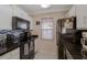 Kitchen with black appliances, granite countertops, and white cabinets at 938 Framlingham Ct # 102, Lake Mary, FL 32746