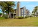 Tan two-story condo building with blue trim, balconies, and landscaping at 938 Framlingham Ct # 102, Lake Mary, FL 32746