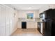 Modern kitchen with white shaker cabinets, black appliances, and granite countertops at 1000 Lake Of The Woods Blvd # A204, Fern Park, FL 32730