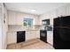 Modern kitchen with white shaker cabinets, black appliances and granite countertops at 1000 Lake Of The Woods Blvd # A204, Fern Park, FL 32730