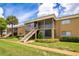 Tan building exterior with stairs and screened balconies at 1000 Lake Of The Woods Blvd # A204, Fern Park, FL 32730