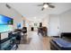 Bright living room features an open floor plan, hardwood floors, and access to the kitchen at 1000 Lake Of The Woods Blvd # A204, Fern Park, FL 32730