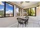 Bright screened porch with wicker furniture and scenic view at 1000 Lake Of The Woods Blvd # A204, Fern Park, FL 32730