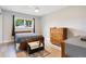Bedroom with wood flooring, dresser, and sliding glass door at 1000 Lake Of The Woods Blvd # A204, Fern Park, FL 32730
