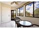 Cozy screened porch with wicker furniture and view of the grounds at 1000 Lake Of The Woods Blvd # A204, Fern Park, FL 32730