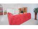 Spacious living room featuring a red sectional sofa at 3070 Silver Fin Way, Kissimmee, FL 34746