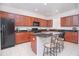 Modern kitchen with granite countertops and wooden cabinets at 3070 Silver Fin Way, Kissimmee, FL 34746