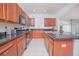 Modern kitchen with granite countertops and wooden cabinets at 3070 Silver Fin Way, Kissimmee, FL 34746