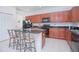 Modern kitchen with granite countertops and wooden cabinets at 3070 Silver Fin Way, Kissimmee, FL 34746