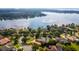 Wide aerial view showing a lakefront home and surrounding neighborhood at 2128 Lake Crescent Ct, Windermere, FL 34786