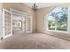 Bright living room with French doors and view to dining area at 2128 Lake Crescent Ct, Windermere, FL 34786