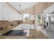 Modern kitchen with granite countertops and white cabinets at 2128 Lake Crescent Ct, Windermere, FL 34786