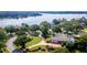 Aerial view of a waterfront home with circular driveway and lush landscaping at 2128 Lake Crescent Ct, Windermere, FL 34786