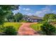 Landscaped front yard with circular driveway leading to a house at 2128 Lake Crescent Ct, Windermere, FL 34786