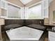 Relaxing bathroom with a corner jacuzzi tub and updated fixtures at 2128 Lake Crescent Ct, Windermere, FL 34786
