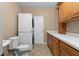 Laundry room with washer, dryer, cabinets, and toilet at 2128 Lake Crescent Ct, Windermere, FL 34786