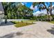 Landscaped front yard with paver driveway and white fence at 5274 Pinto Way, Orlando, FL 32810